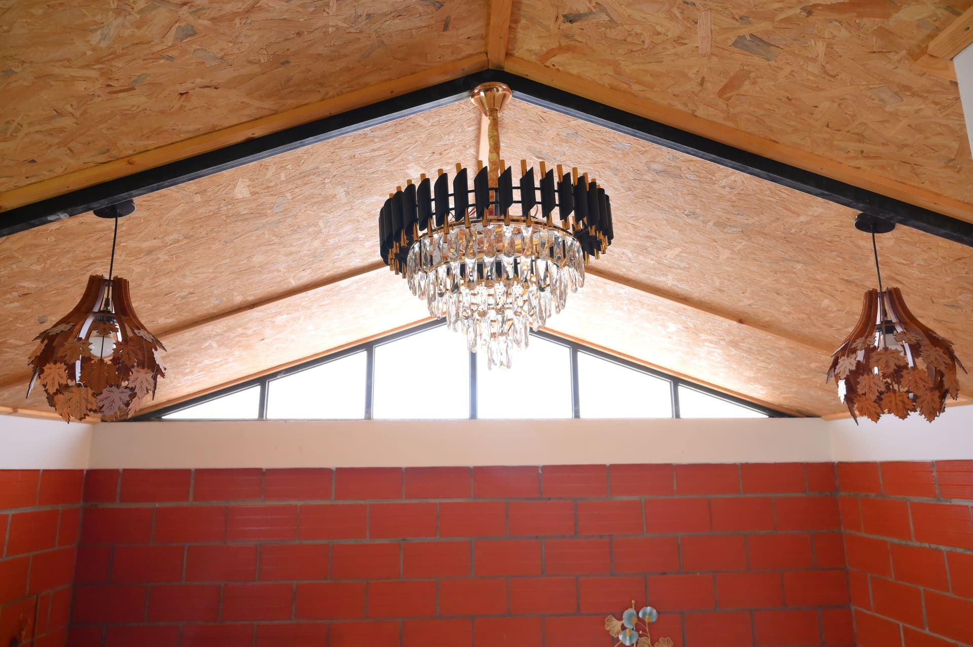 OSB compressed woodchip ceiling with crystal chandelier at The Urban Loft